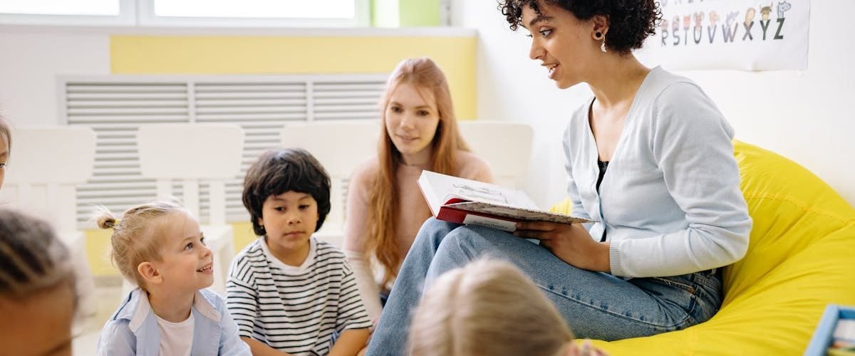 Teacher reading to preschool kids in a colorful classroom setting.